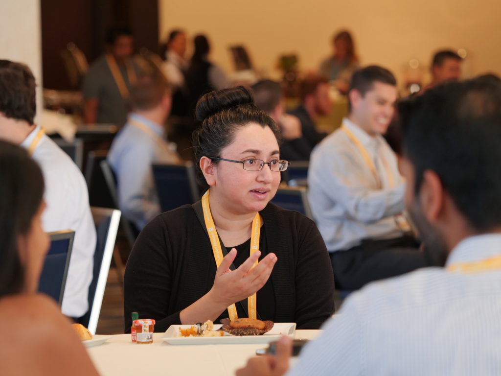 Attendees speaking at conference table