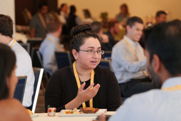 Attendees speaking at conference table