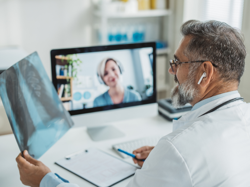 Radiologist reading scan at computer