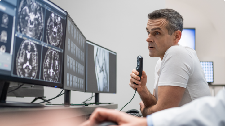 radiologist reading scans on desktop