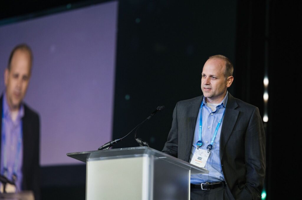 man stands at a podium speaking