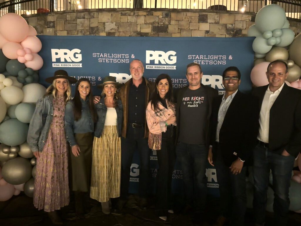 Dr. B smiling with a group of people at one the of the Pink Ribbon Good events