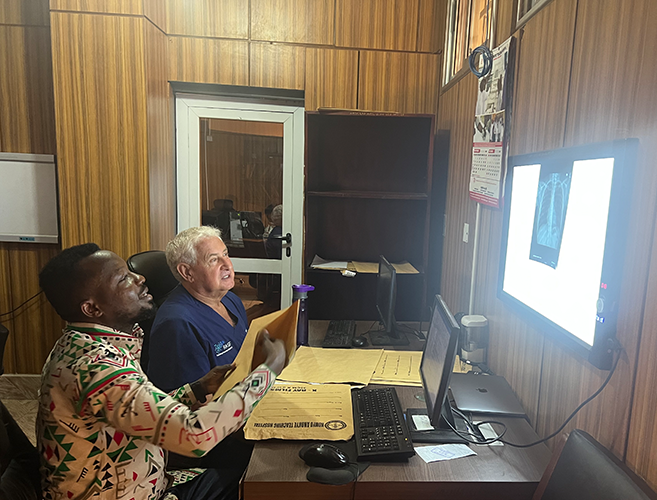 two men reviewing a radiograph in a reading room